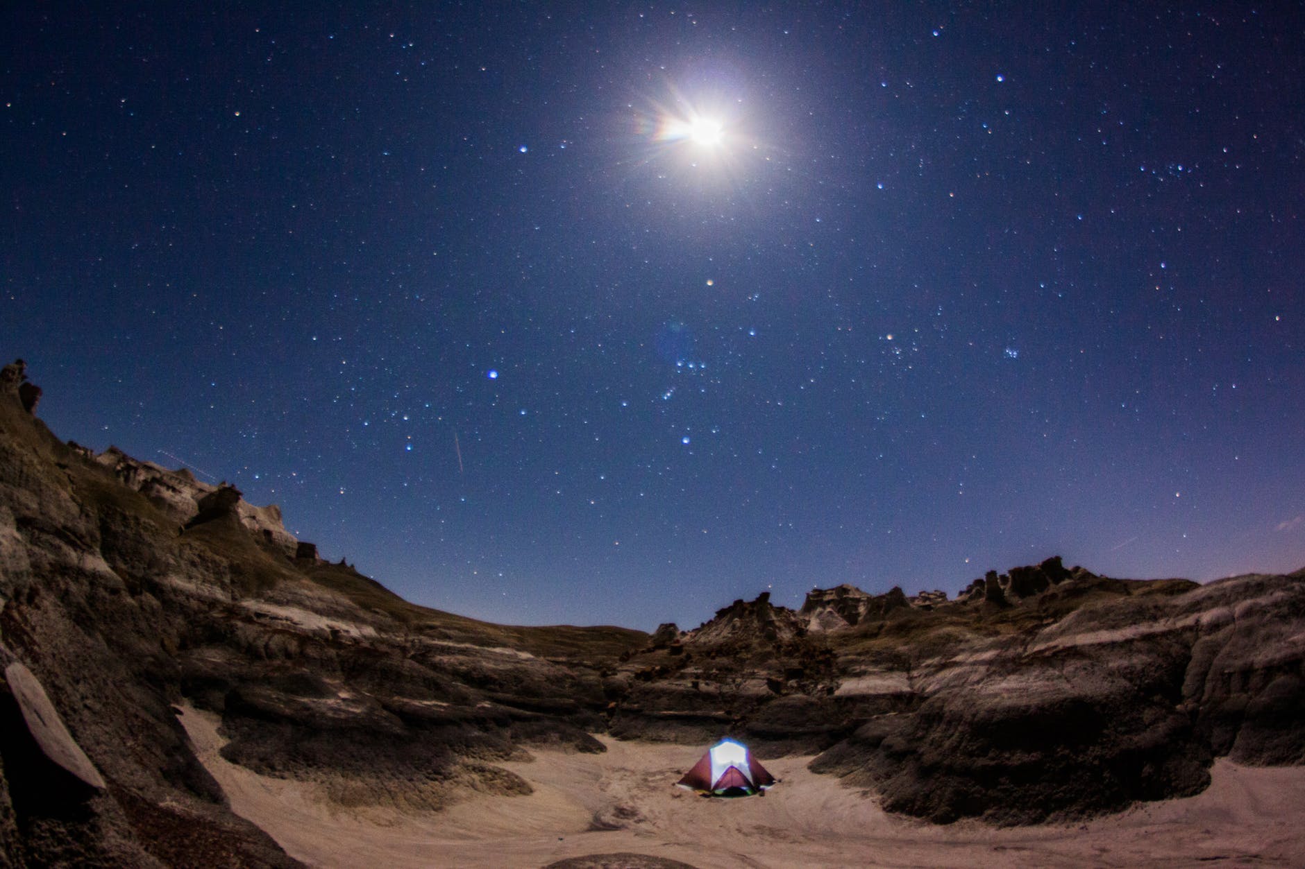 photograph of camping tent under starry sky